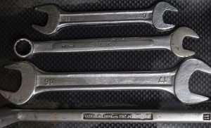 Nut wrenches on a reflective carbon fiber surface. Tools and equipment